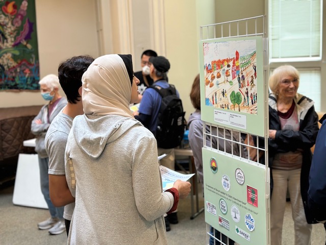 Viewers at the exhibit “A Child’s View of Gaza” at Montclair Unitarian Universalist rotunda, 16 April 2023