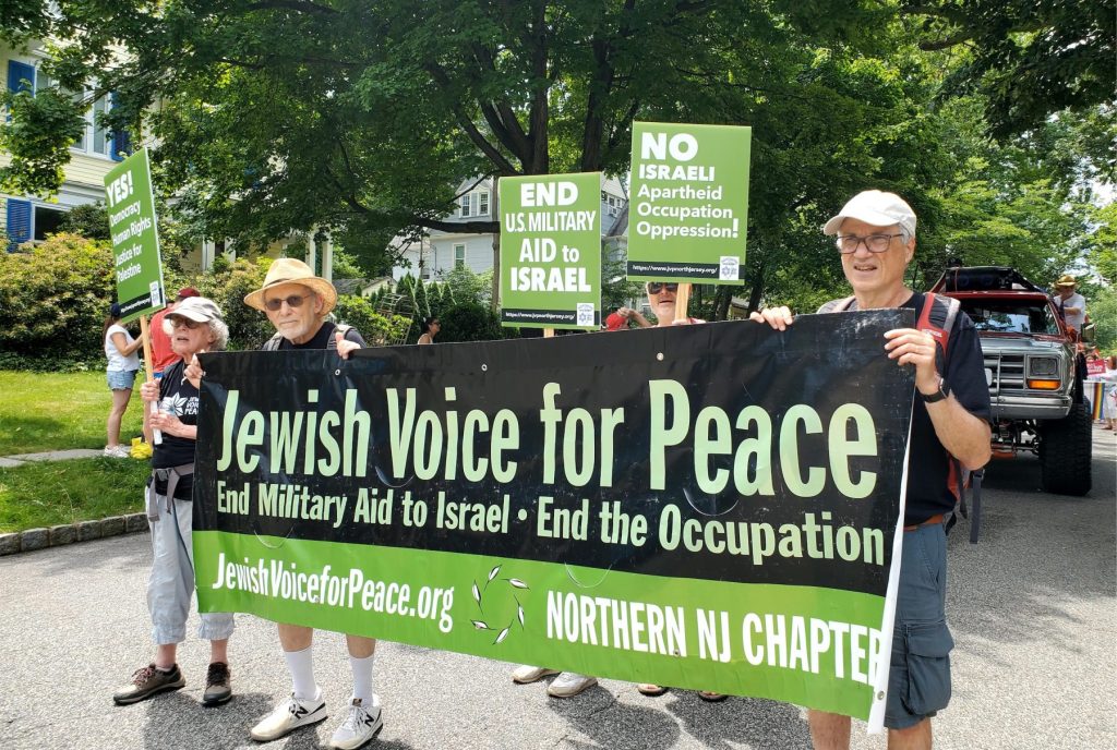 Members of NNJ JVP with banner and signs reading “End U.S. Military Aid to Israel” and “No Israeli Apartheid • Occupation • Oppression”