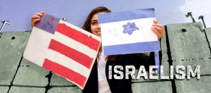 woman stands in front of wall with amateurish cartoons of U.S.American and Israeli flags “Israelism”