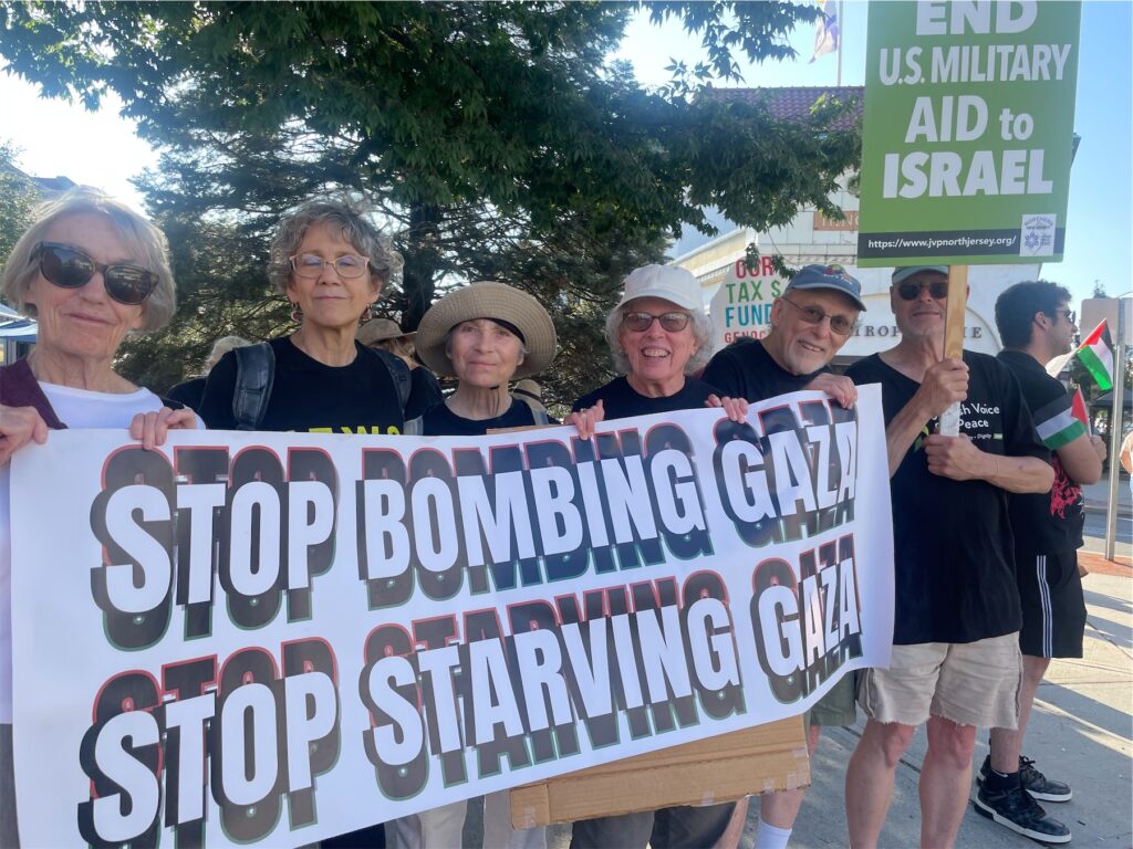 Members of Northern New Jersey JVP holding a banner reading Stop Bombing Gaza Stop Starving Gaza and a sign saying End U.S. Military Aid to Israel