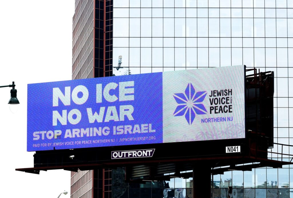 Billboard, mostly purple and white, says NO ICE NO WAR STOP ARMING ISRAEL Paid for by Jewish Voice for Peace Northern NJ | JVPNorthJersey.org